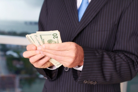 Executive pay Businessman holding money