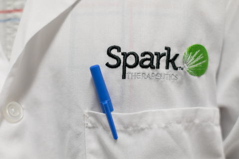 Spark Therapeutics Spark Therapeutics logo on labcoat