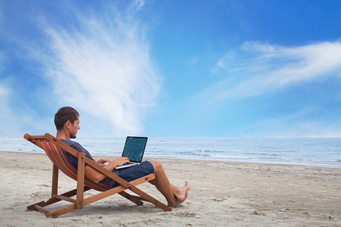 Beach Office Getty businessman working with computer on the beach