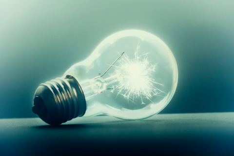 Light bulb on dark background on its side Light bulb on dark background