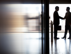 Business shaking hands deals M&A CREDIT: Getty/Sam Edwards Two businessmen shaking hands in a hallway