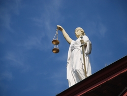 Law Statue holding justice scales