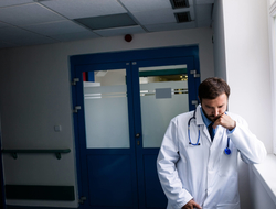 Doctor burnout Doctor pausing with a frown on his face