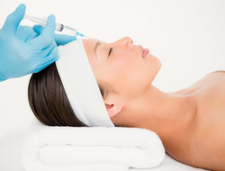 Woman receiving Botox injection on her forehead. Woman receiving Botox injection on her forehead.