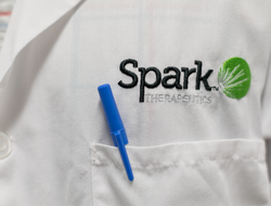 Spark Therapeutics Spark Therapeutics logo on labcoat