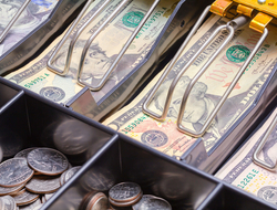 Cash drawer full of bills and coins Cash register full of money