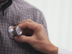 Heart doctor Doctor putting stethescope to patient's chest