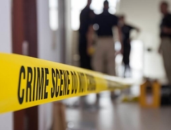Crime Scene gun violence shooting shooter emergency generic abstract police Crime scene tape in a building with blurred forensic team in background