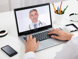 telehealth computer screen patient doctor (Getty/AndreyPopov) Businessman video-chats with doctor on laptop