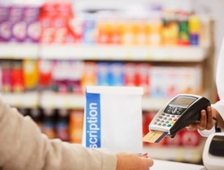 Healthcare costs drug prices prescriptions medication pharma pharmacy benefits credit payment copay (Getty/Tom Merton) Woman paying for a prescription at a pharmacy