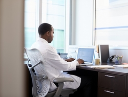 Doctor physician working healthcare desk laptop health IT CREDIT: Getty/monkeybusinessimages A doctor sitting at his desk working on a laptop computer.