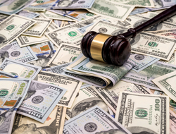 Gavel on pile of money Gavel on top of cash