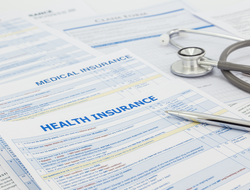 Health insurance forms Stack of health insurance application forms with stethoscope on top