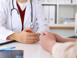 doctor with patient Photo of doctor and patient hands while discussing medical records after health examination