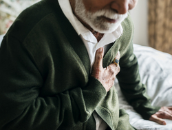 elderly patient at home photo of elderly man having heart problems holding his chest