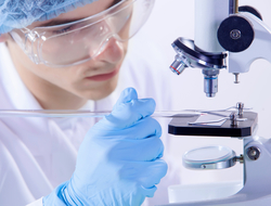 Medical research A medical researcher conducting an experiment using a microscope