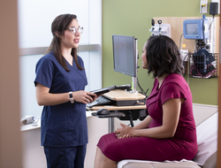 Employer health clinic A woman is treated by a female nurse