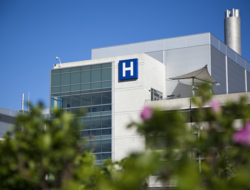 Hospital A photo of the exterior of a hospital on a sunny day