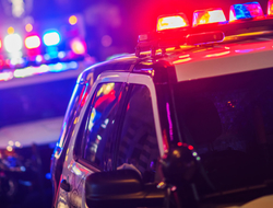 Two police vehicles at night with lights on Two law enforcement vehicles with lights on at night