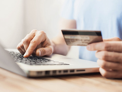 Credit Card Online Shopping Getty Young man shopping with credit card and laptop computer