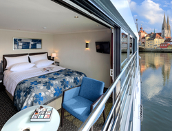 Avalon Waterways Panorama Suite An open Avalon Waterways panorama suite with a town visible in the background