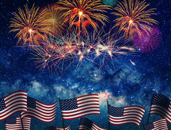 Fourth of July Getty American flags with Fourth of July fireworks overhead