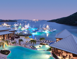 Scrub Island Resort Dusk A view of the tiered infinity pools and marina at dusk