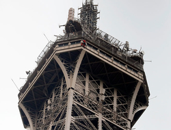 Man Climbing Eiffel Tower Newscred Editorial Travel Group Only A rescue worker hangs from the Eiffel Tower.