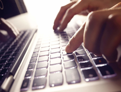 Hands typing on a laptop keyboard Hands typing on a laptop