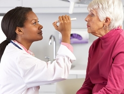 Doctor physician eye exam senior patient healthcare A doctor examining a patient's eyes