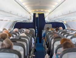 Airplane cabin with passengers - AlxeyPnferov/iStock/Getty Images Plus/Getty Images Airplane cabin with passengers
